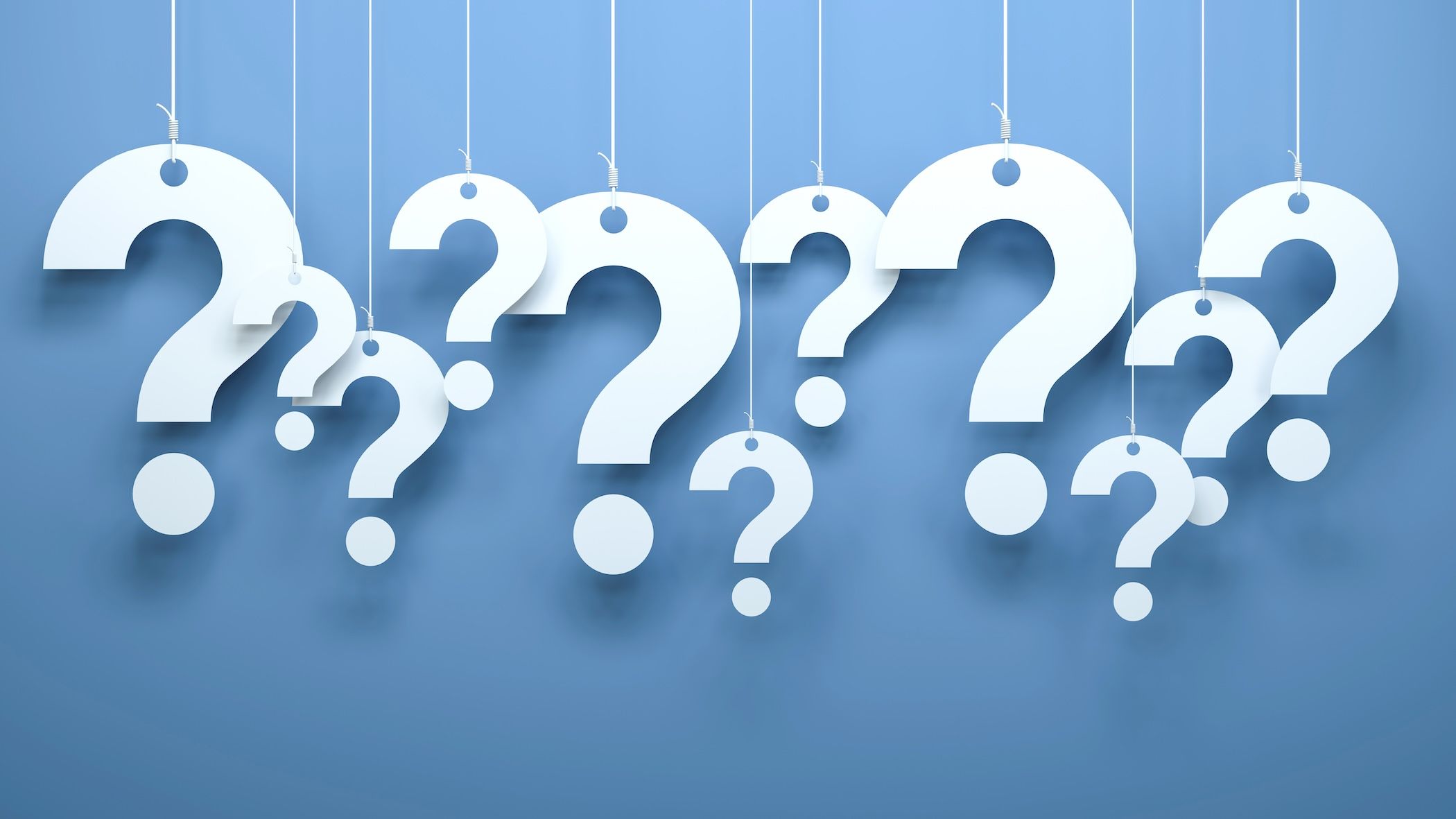 White question marks in front of blue background.